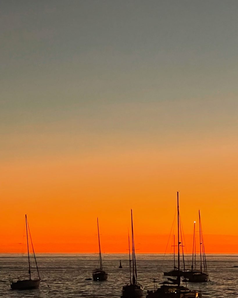 Sailboats at anchor during a golden sunset in St Barth