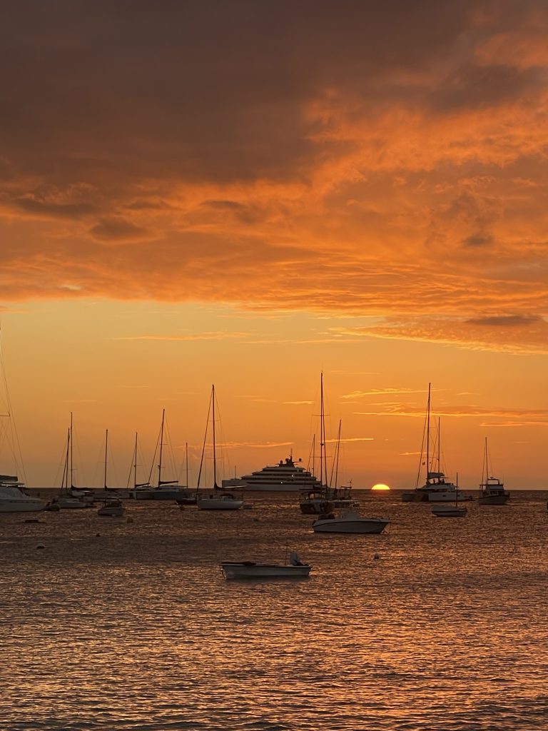 Sailboats at anchor during a golden sunset in St Barth