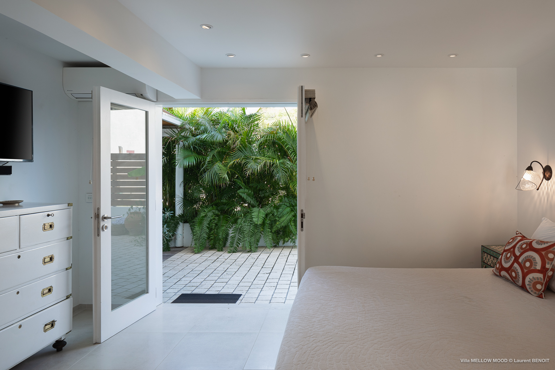 Master bedroom with TV and garden access